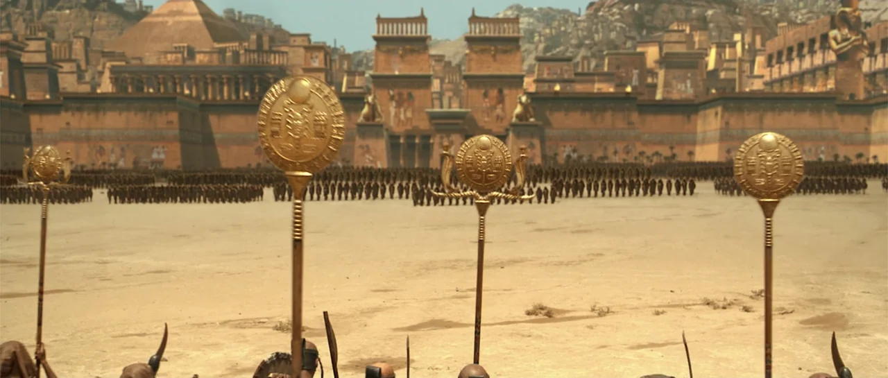 The Mummy Returns (2001) movie still: wide — A sprawling ancient desert military encampment features massive stone walls and pyramidal structures. A…