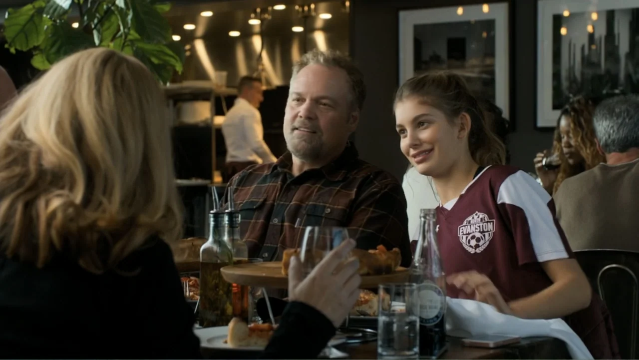 Death Wish (2018) movie still: medium — A restaurant dining area features tables with patrons and a professional kitchen background. A man and a…