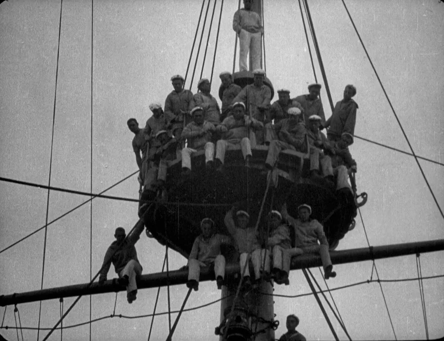 Battleship Potemkin (1925) movie still: wide — A high, precarious circular metal platform built onto the mast of a naval ship. Sailors occupy every…