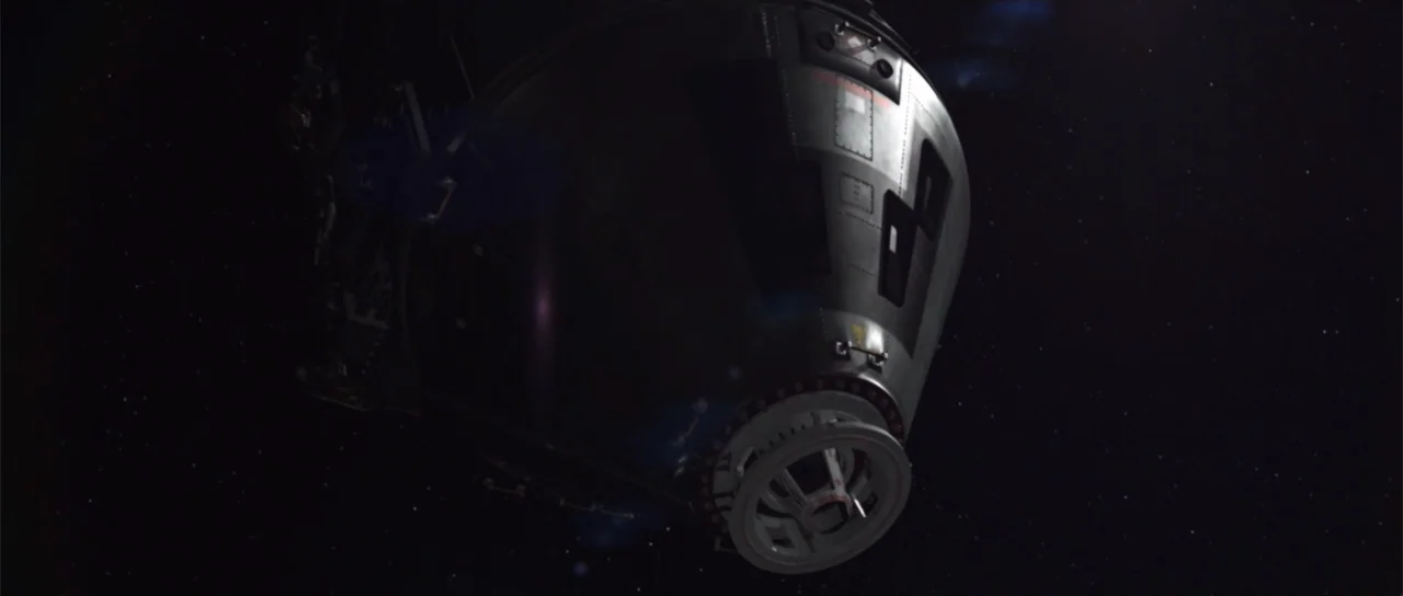 Astronaut: The Last Push (2012) movie still: fullbody — A metallic space command module drifts through the dark void of outer space. Tiny stars are…