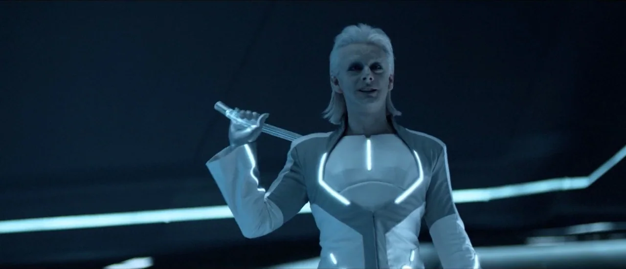 TRON: Legacy (2010) movie still: medium — A dark, expansive digital environment is defined by horizontal neon light strips. A person with white hair…