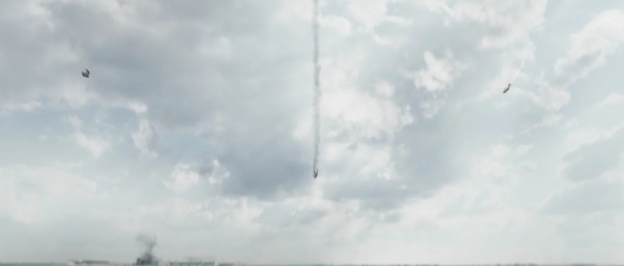 Captain America: Civil War (2016) movie still: establishing — A vast, cloudy sky fills the frame during the day. Three small airborne objects fall…