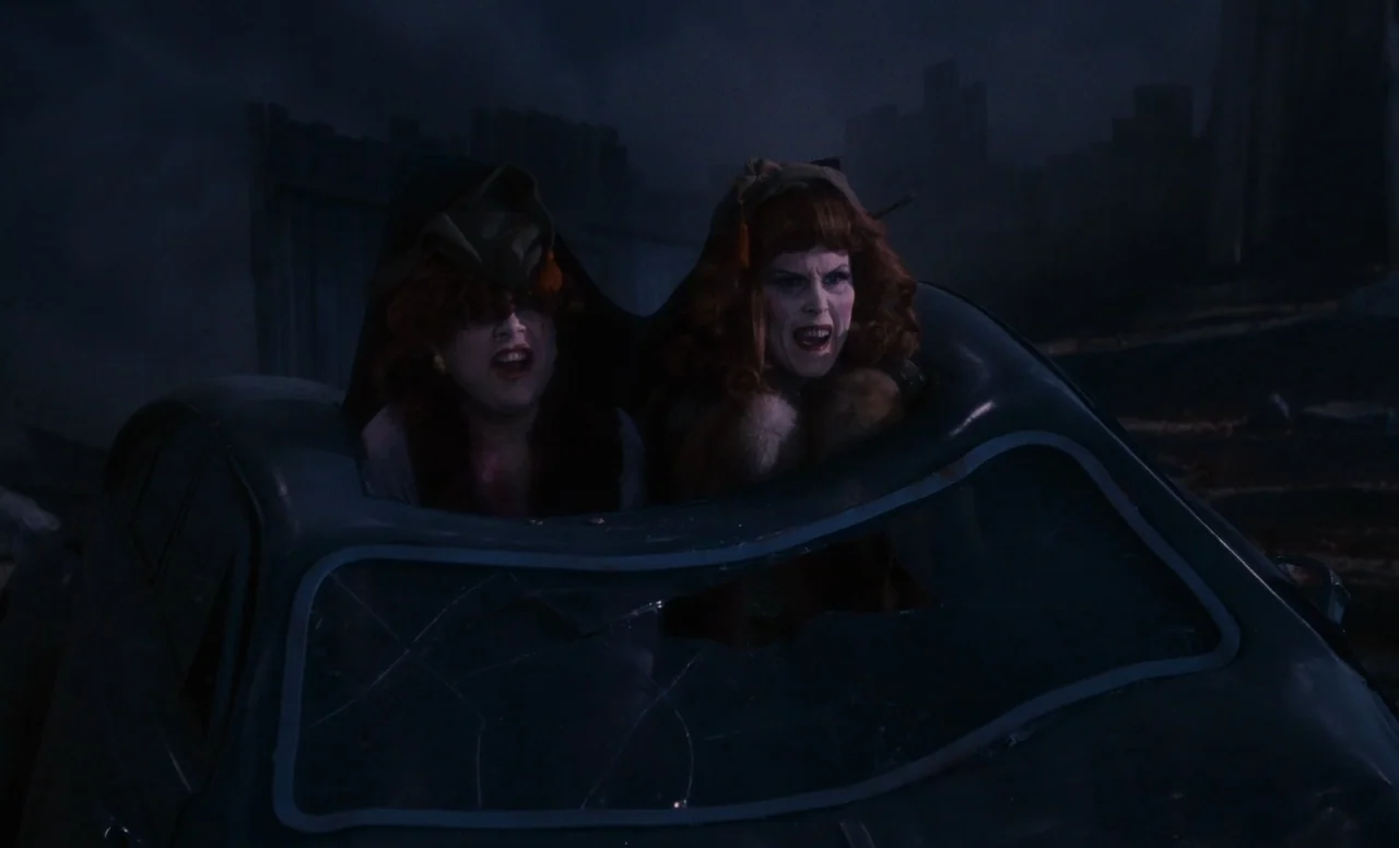James and the Giant Peach (1996) movie still: medium — Two women with red hair sit inside a wrecked car frame at night. They both scream while…