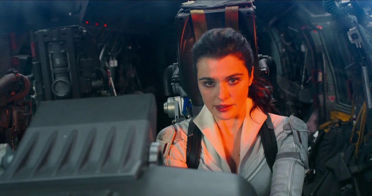 Black Widow (2021) movie still: medium — The interior of a high-tech aircraft cockpit is dark with various metallic instruments visible. A woman…