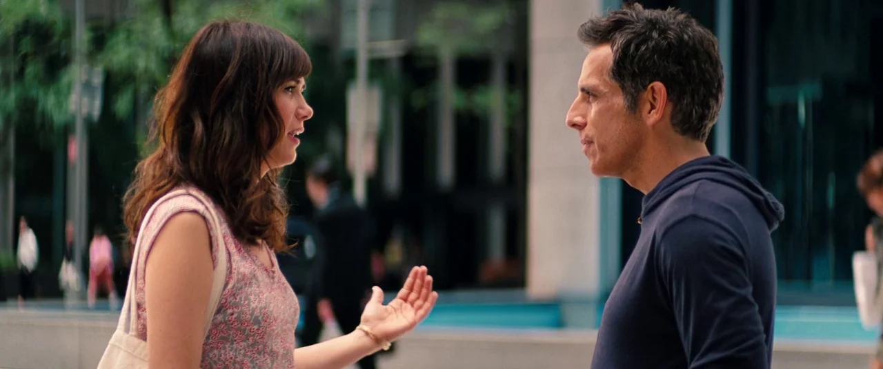 The Secret Life of Walter Mitty (2013) movie still: medium — A metropolitan sidewalk area features blurred glass buildings in the background. A…