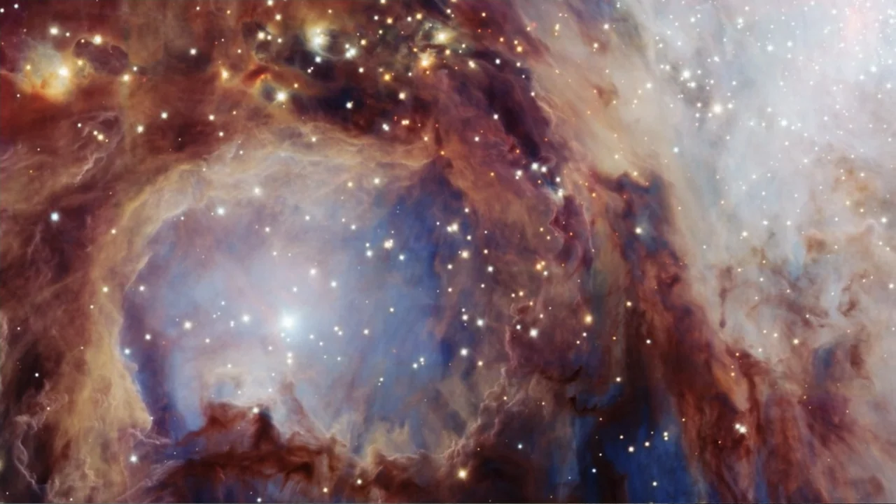 Beware of Angels (2016) movie still: establishing — Vast clouds of interstellar dust and gas swirl against the dark background of space. Numerous…