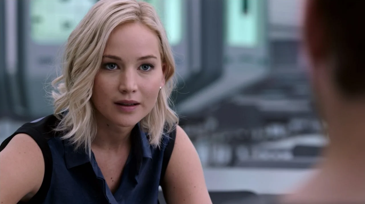Passengers (2016) movie still: medium — A modern, sterile-looking interior with smooth, light grey metallic surfaces and blurred panels. A blonde…