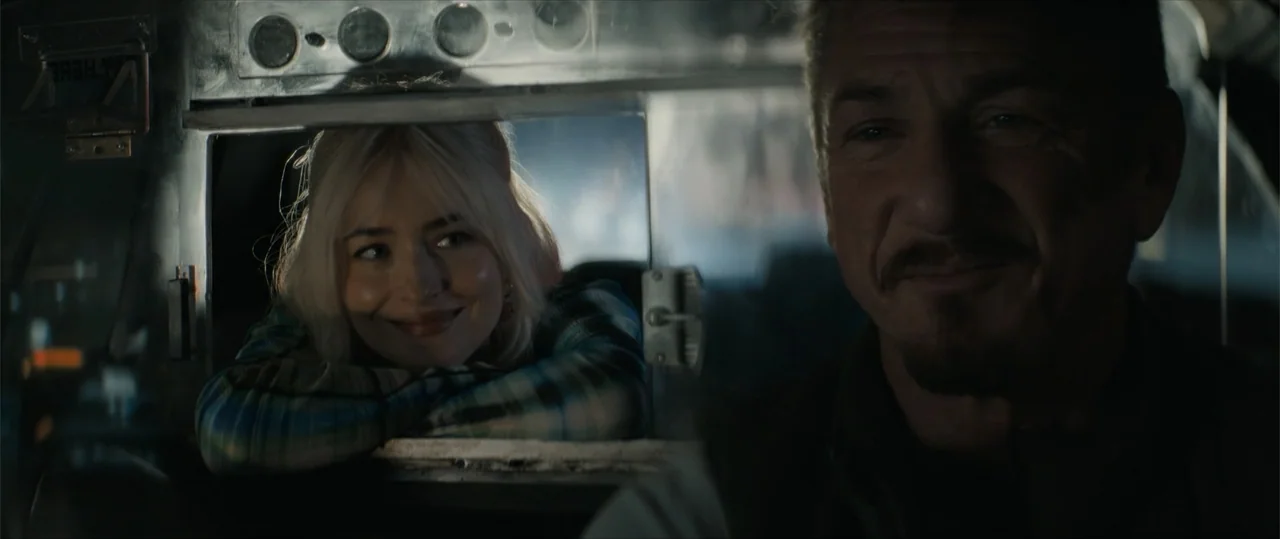 Daddio (2024) movie still: medium — The interior of a vehicle separates a male driver from a blonde female passenger. The man sits in the front…