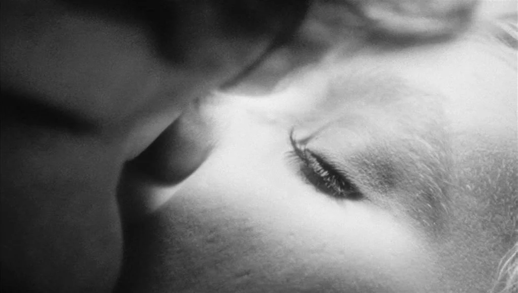Who’s That Knocking At My Door (1967) movie still: closeup — A close-up view of a person's face pressed against another person's neck. The scene is…