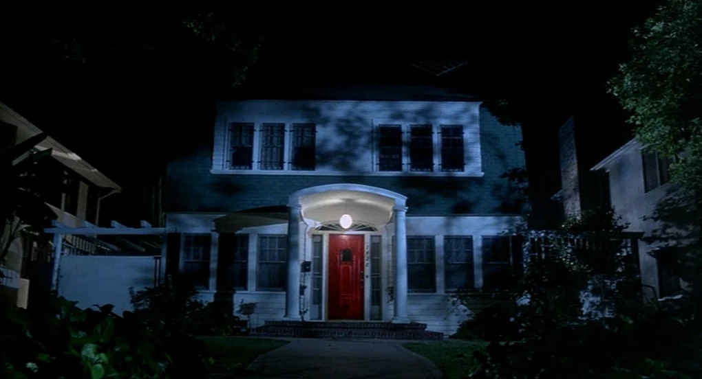 A Nightmare On Elm Street 2: Freddy’s Revenge (1985) movie still: establishing — A two-story suburban home with a dark exterior is positioned at…