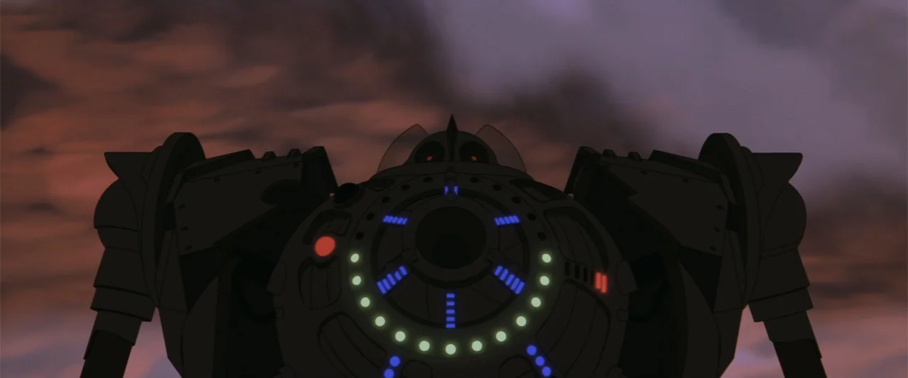 The Iron Giant (1999) movie still: medium — A dark, complex robotic torso is centered against a dark purple and red sky. The mechanical unit…