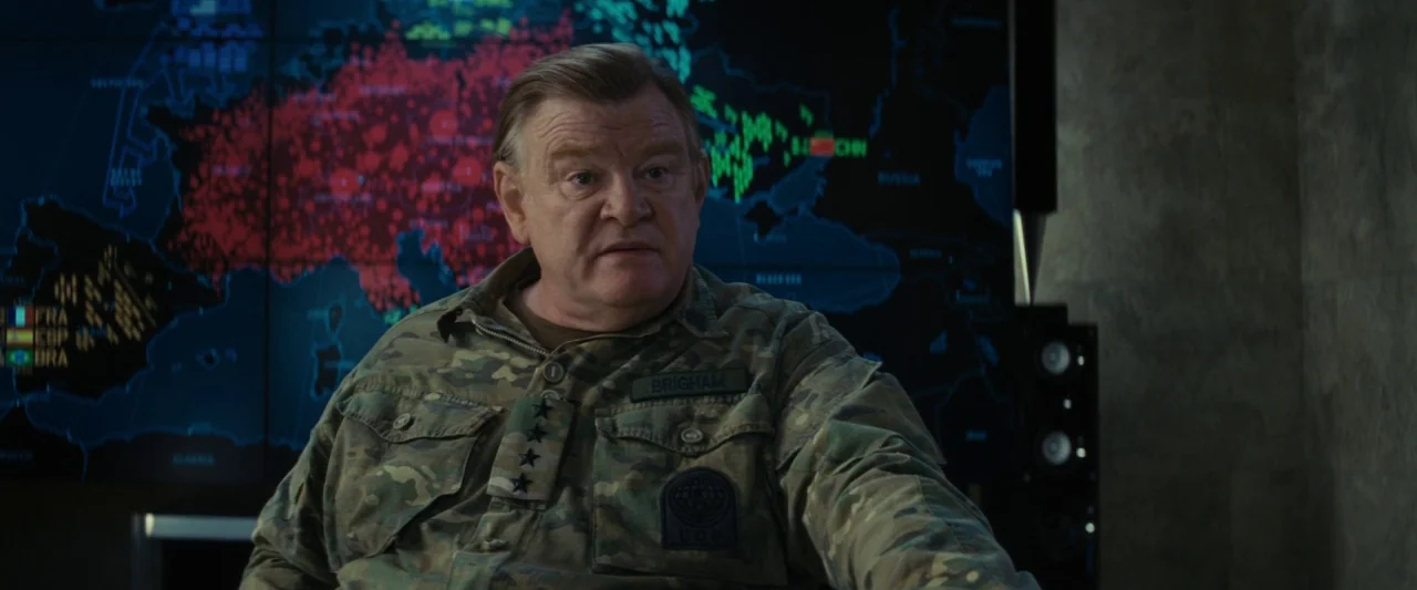 Edge of Tomorrow (2014) movie still: medium — A dimly lit military operations room features a large, glowing digital world map display. A senior…