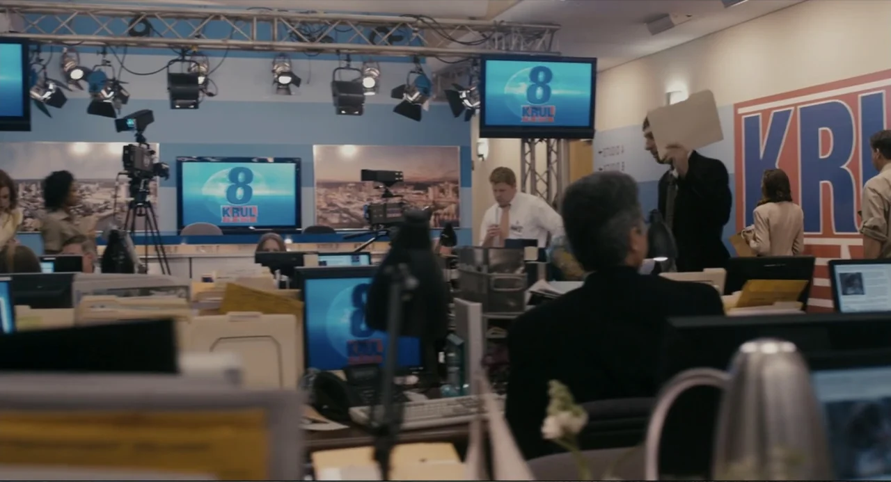Beyond a Reasonable Doubt (2009) movie still: wide — A busy television newsroom office featuring rows of computer workstations under studio lighting…