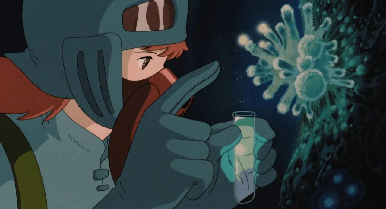 Nausicaä of the Valley of the Wind (1984) movie still: medium — A dark, cramped space filled with glowing biological samples and complex, mysterious…