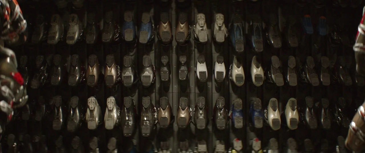 Force Majeure (2014) movie still: wide — Rows of ski boots are neatly stored on a vertical metal rack system. Multiple pairs of footwear are…
