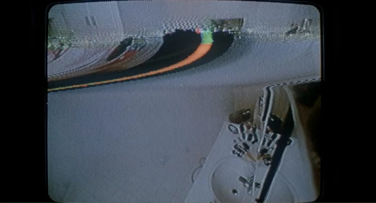 F/X2 (1991) movie still: wide — An empty room contains a white sink basin and tiled floor. Video scanlines and magnetic tape glitches distort the…