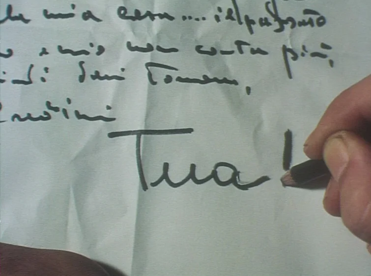 Hermitage (1968) movie still: closeup — A piece of white paper with deep creases is held steady for writing. A person's fingers grip a black pencil…