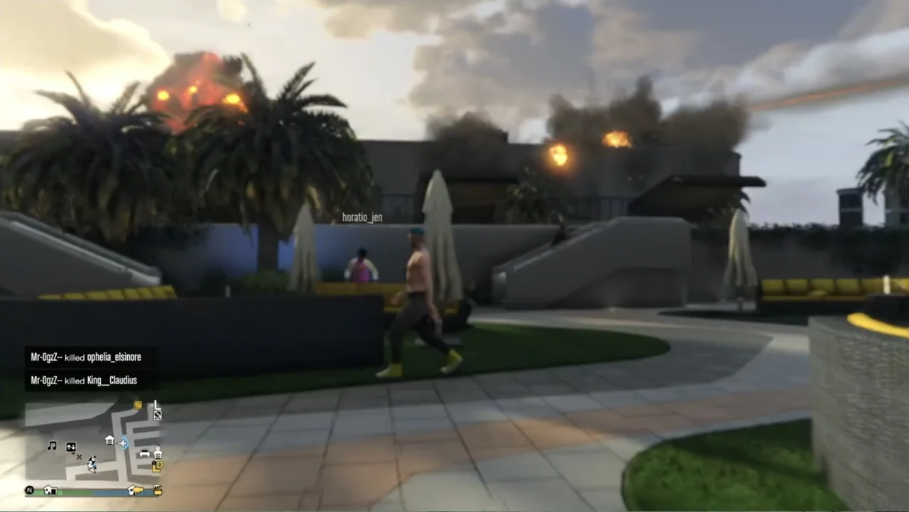 Grand Theft Hamlet (2024) movie still: medium — A luxury hotel poolside area features modern outdoor furniture and palm trees at dusk. A shirtless…