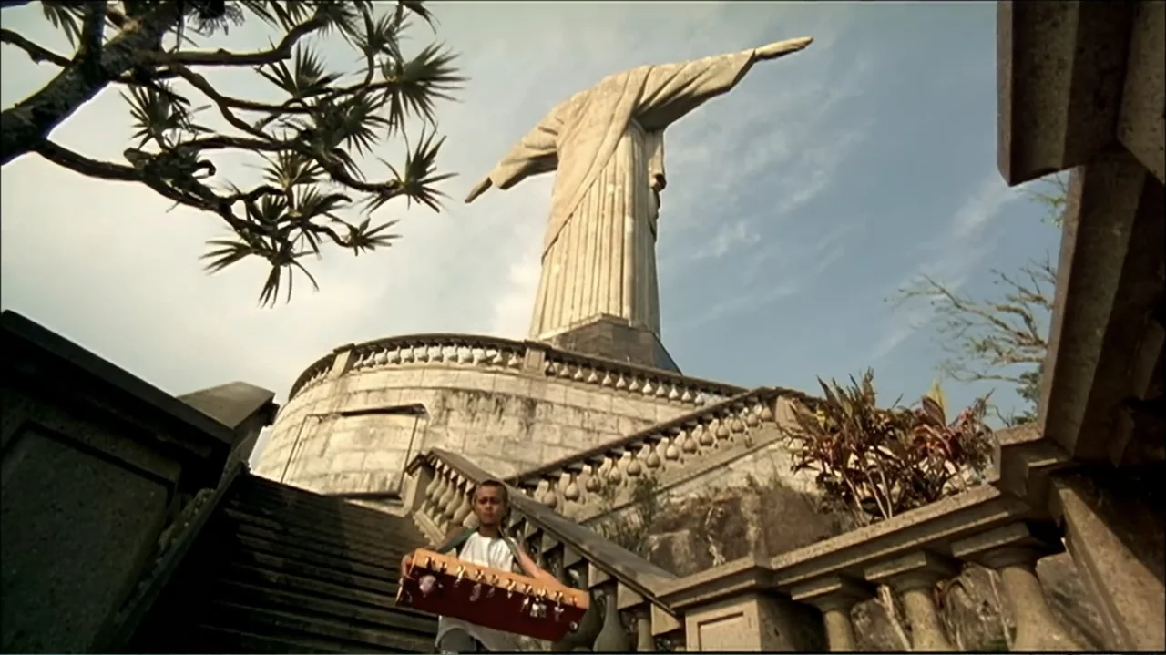 In the Middle of the World (1990) movie still: fullbody — A young boy walks down the grand stone staircase of a massive monumental structure. The…