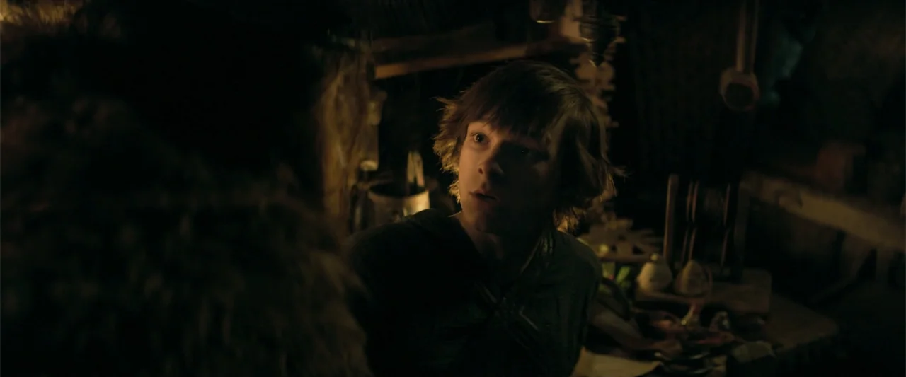 How to Train Your Dragon (2025) movie still: medium — A dimly lit, cluttered workshop filled with wooden tools and rustic objects in shadows. A…