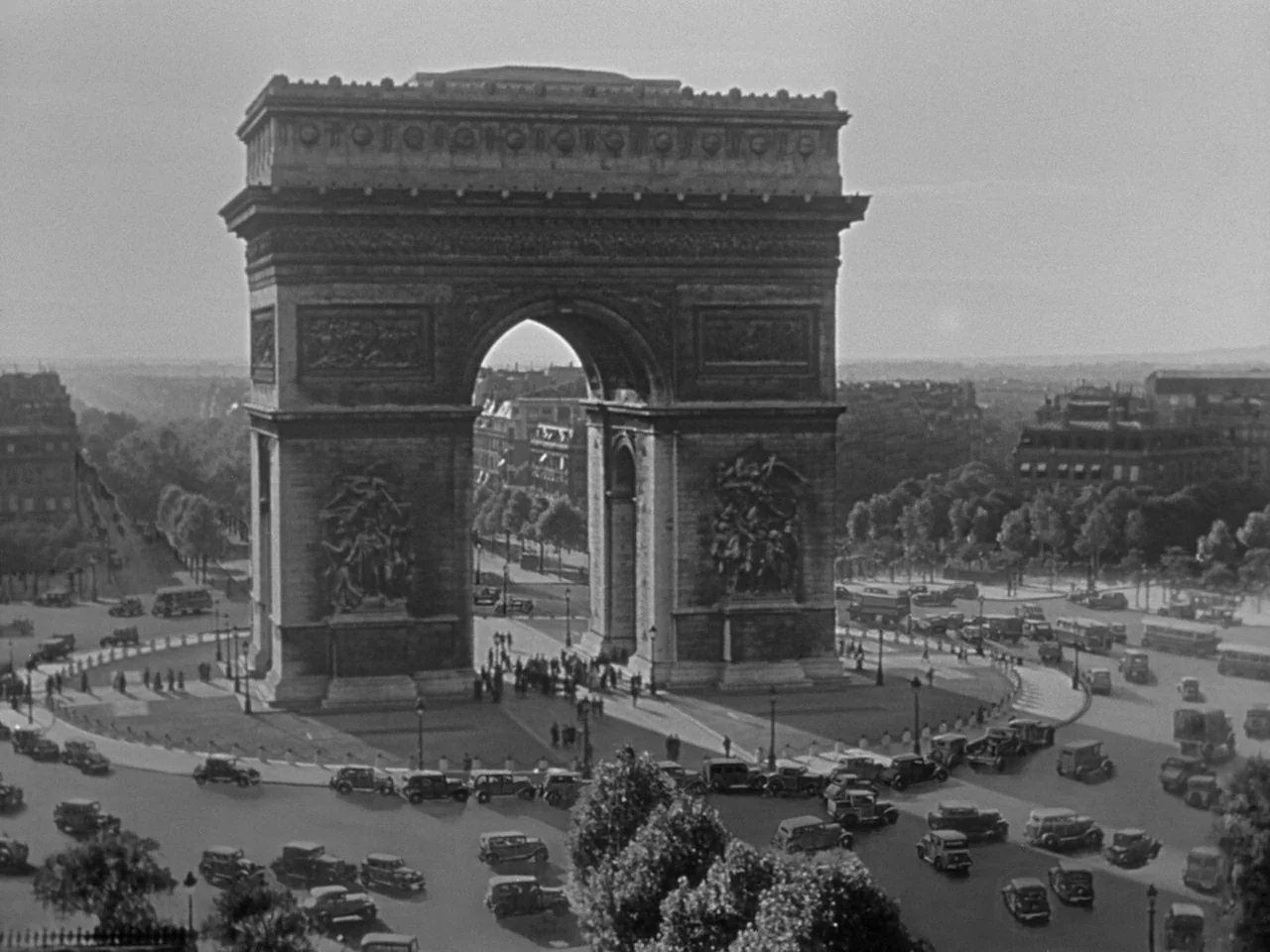The Day the Earth Stood Still (1951) movie still: establishing — The Arc de Triomphe stands centrally in a bustling Parisian traffic circle.…