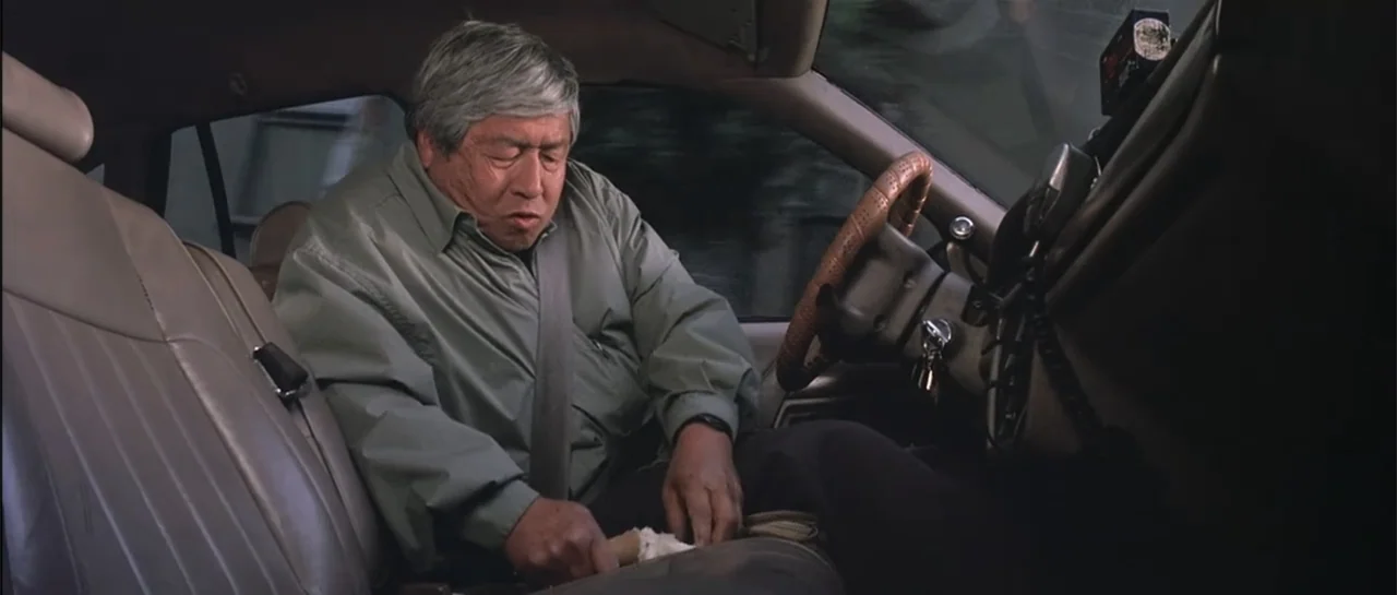 The Wedding Planner (2001) movie still: medium — An interior of a parked car shows a dashboard, steering wheel, and leather upholstery. An older man…