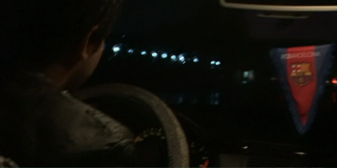 Silencing the Song: An Afghan Fallen Star (2011) movie still: medium — A dark vehicle interior with the silhouette of a driver seen from behind. The…