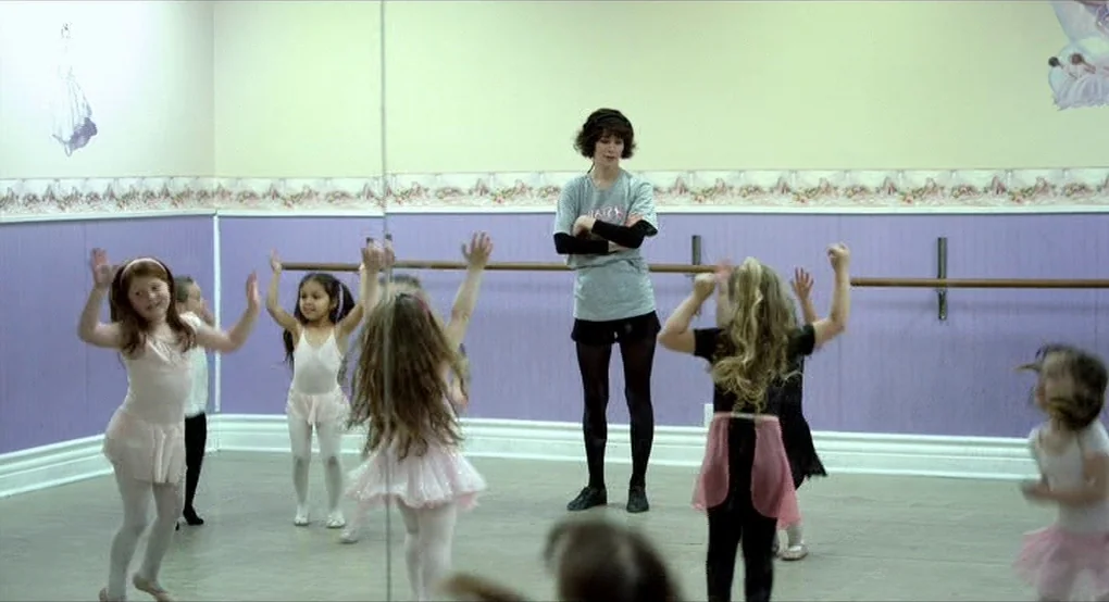 The Future (2011) movie still: wide — A dance studio features lavender lower walls and pale yellow upper walls with murals. A group of children in…