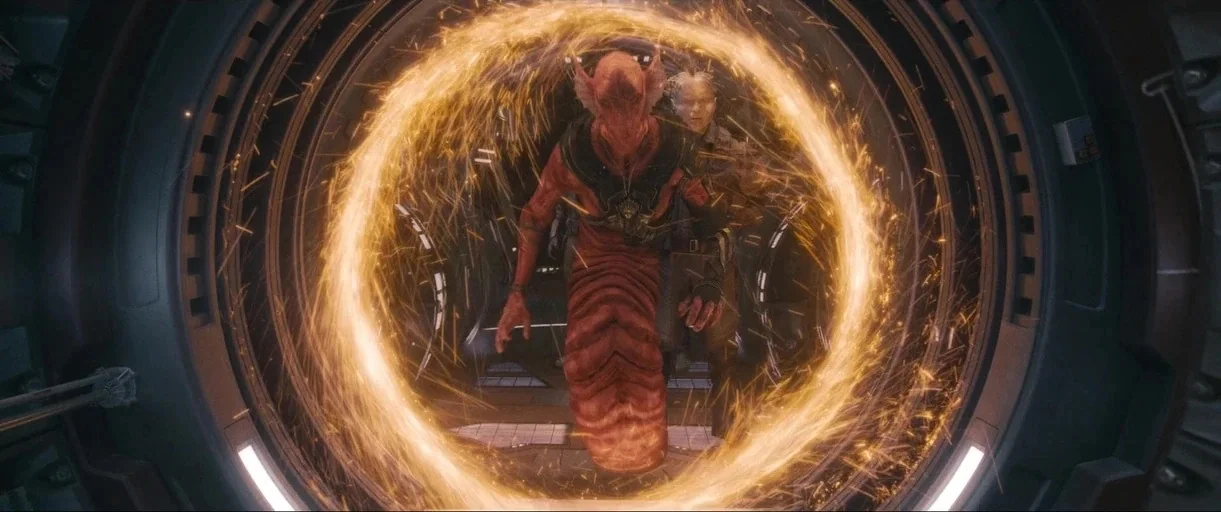 Guardians of the Galaxy Vol. 3 (2023) movie still: medium — A metallic interior corridor with curved walls houses a glowing circular energy gateway.…