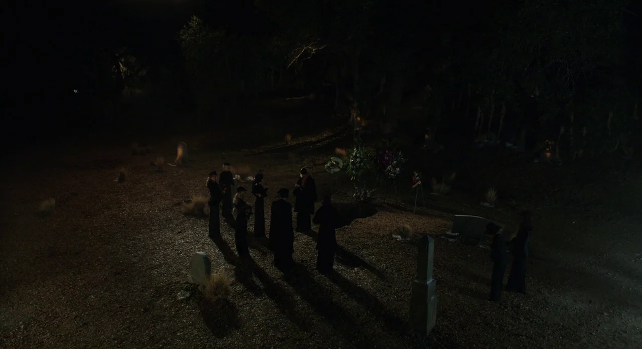 A Glimpse Inside The Mind Of Charles Swan III (2013) movie still: wide — A desolate burial ground at night featuring multiple gravestones scattered…