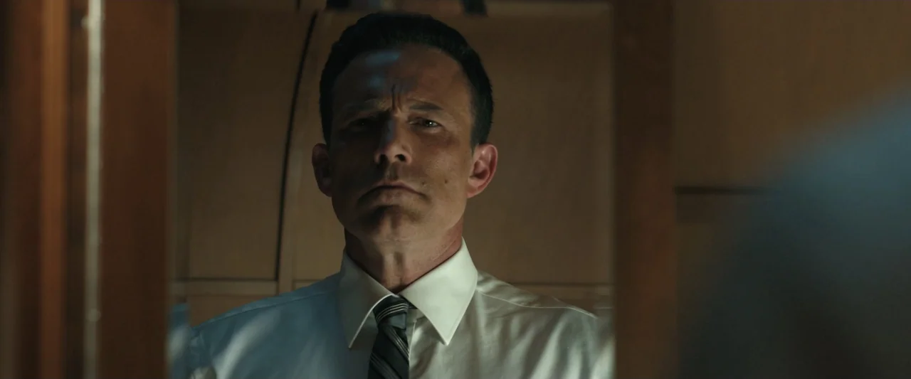 True Account: Breaking the Truce (Yakuza Bloody Chronicles 2) (2007) movie still: closeup — A dimly lit room with a man standing centered before a…