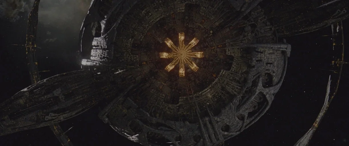 Transformers: Rise of the Beasts (2023) movie still: establishing — A massive, intricate circular space station floats against the black backdrop of…