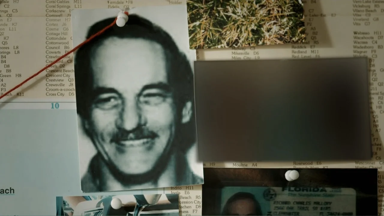 Aileen Wuornos : Mind of a Monster (2020) movie still: closeup — A close-up view of a cork bulletin board covered with maps and pinned photographs.…