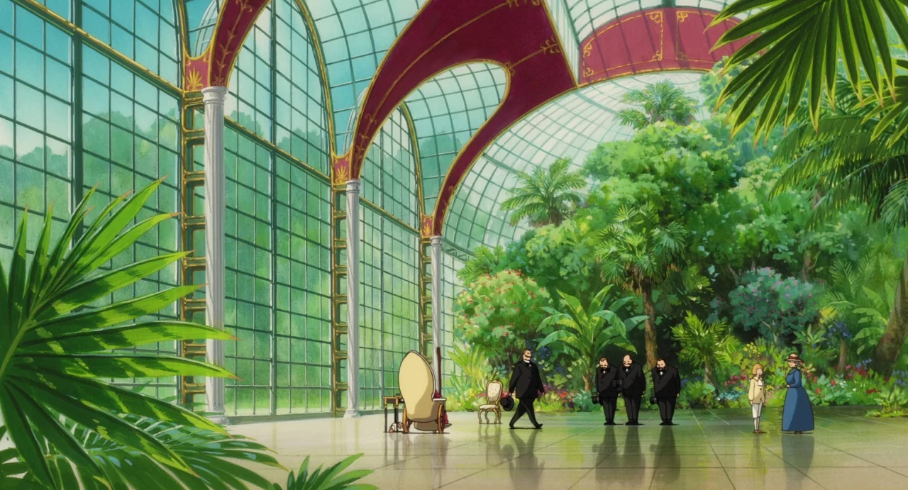 Howl’s Moving Castle (2004) movie still: wide — A large indoor glass conservatory with high arched windows and lush potted tropical plants. A group…