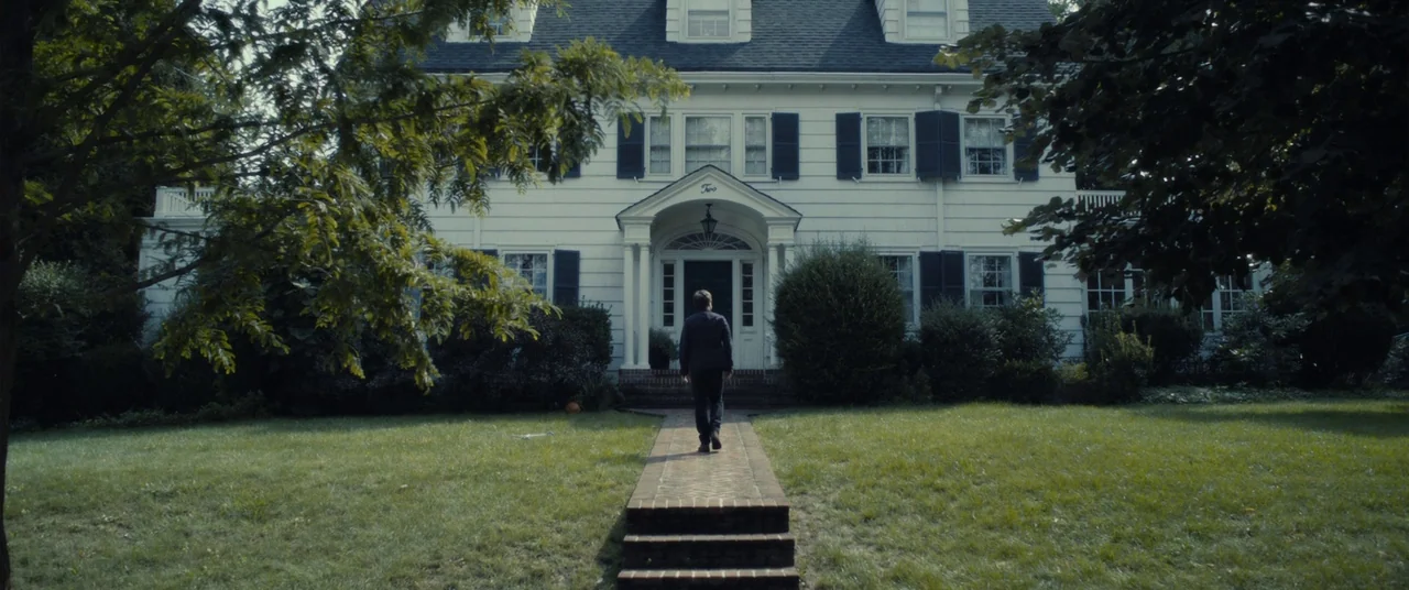 The Disappearance of Eleanor Rigby: Him (2014) movie still: wide — A two-story white suburban house features black shutters and a brick walkway. A…