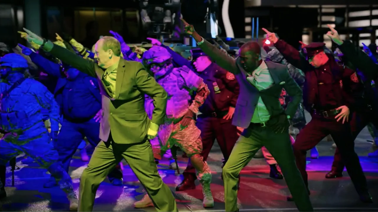 Ghostbusters (2016) movie still: fullbody — A dark urban street at night filled with people in suits and tactical uniforms. The group performs a…