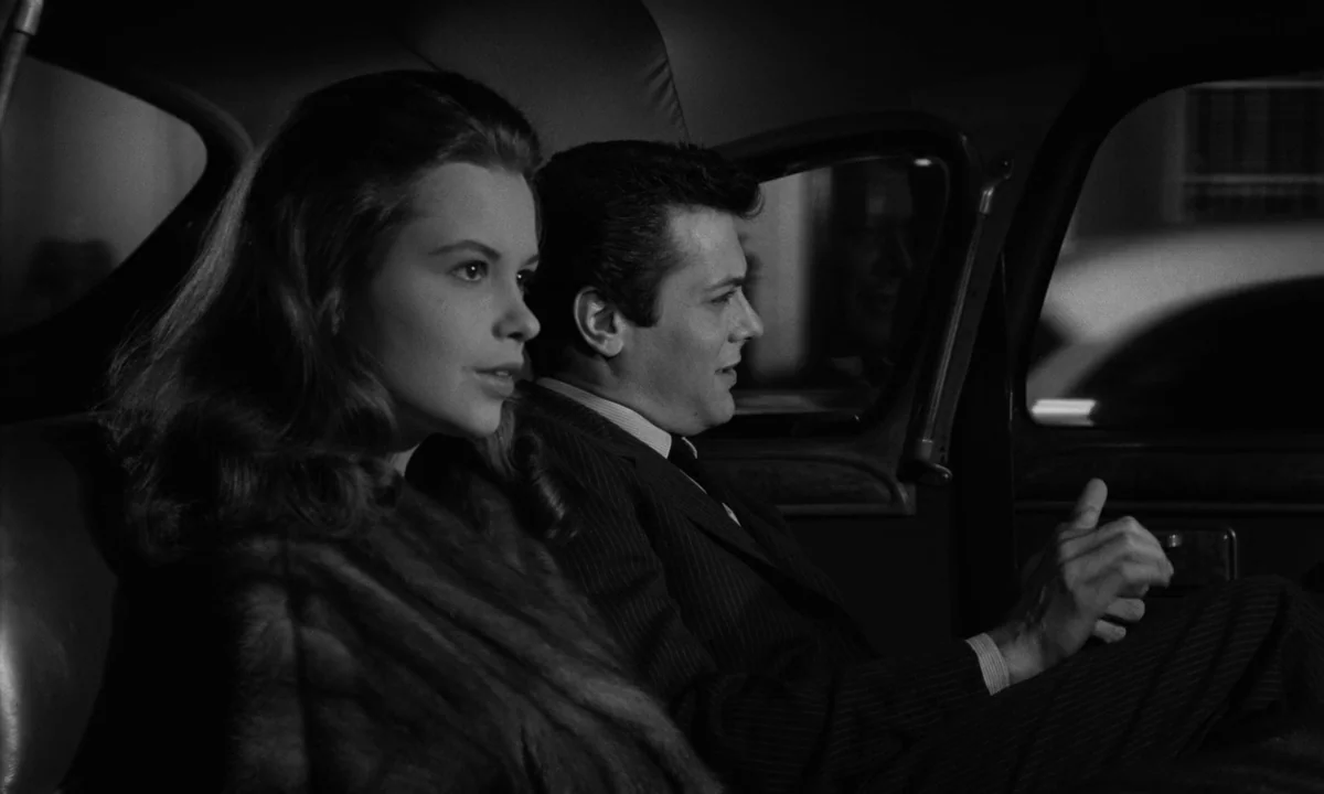 Sweet Smell of Success (1957) movie still: medium — A dark, cramped interior of a vintage automobile at night. A young couple sits together in the…