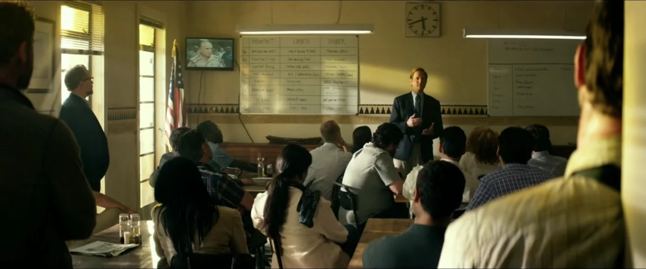13 Hours: The Secret Soldiers of Benghazi (2016) movie still: medium — A room with a whiteboard showing meal schedules and a television displaying a…