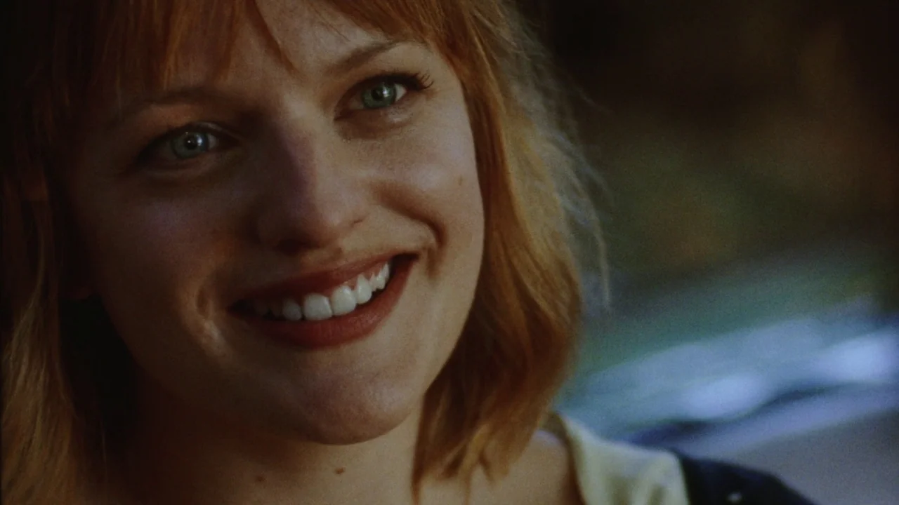 Queen of Earth (2015) movie still: closeup — The interior of a vehicle during daylight provides a soft, diffused light source. A woman with reddish…