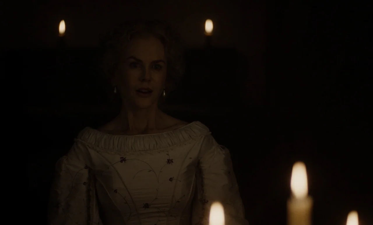 The Beguiled (2017) (2017) movie still: medium — A dimly lit Victorian-style interior is illuminated solely by several glowing candles. A woman in…