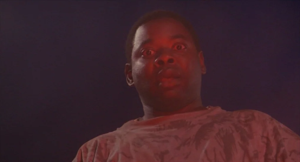 A Nightmare On Elm Street 4: The Dream Master (1988) movie still: closeup — A dark, nondescript interior space is bathed in intense red light. A…