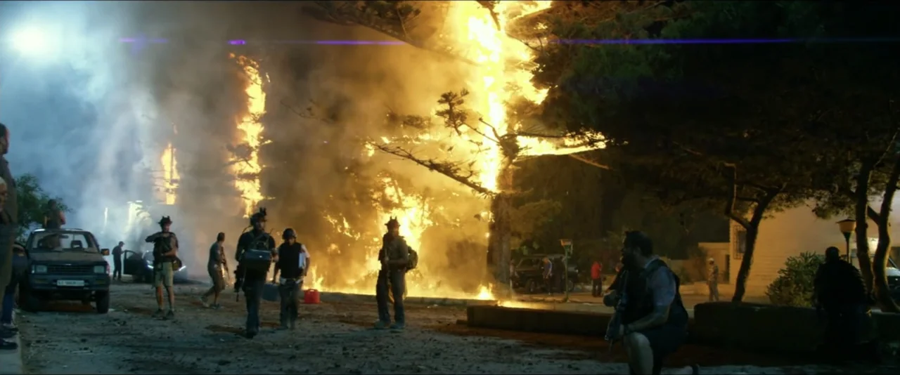 13 Hours: The Secret Soldiers of Benghazi (2016) movie still: wide — A dark residential area features a massive, uncontrolled fire consuming a large…