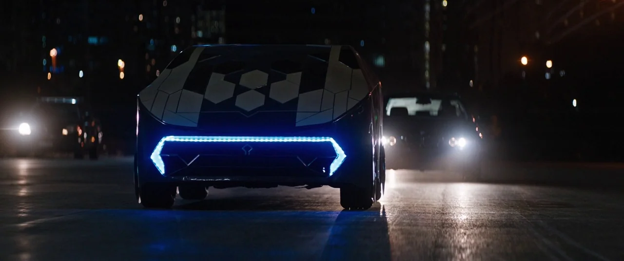 Upgrade (2018) movie still: medium — A futuristic car with hexagonal patterns and bright blue lighting travels along a dark road. Two other vehicles…