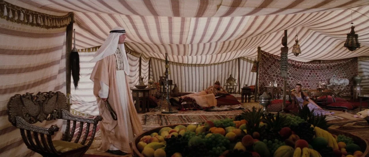 The Spy Who Loved Me (1977) movie still: wide — A spacious tent interior features striped fabric walls and ornate rugs across the floor. A man in…