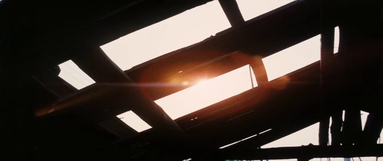 Lady Snowblood Song of Vengeance (1974) movie still: establishing — A view looking up through the missing slats of a derelict wooden ceiling…