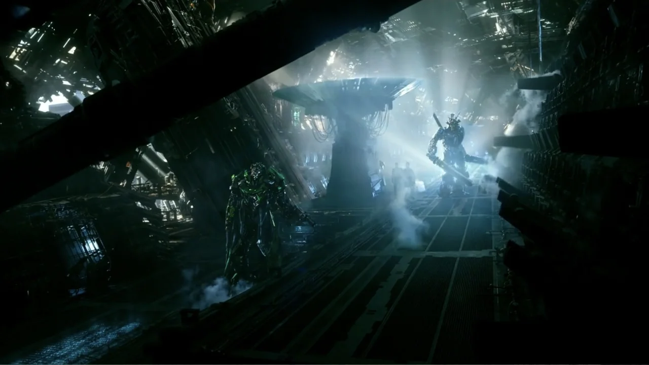 Transformers: Age of Extinction (2014) movie still: wide — A dark metallic interior corridor features complex machinery, ventilation grates, and…