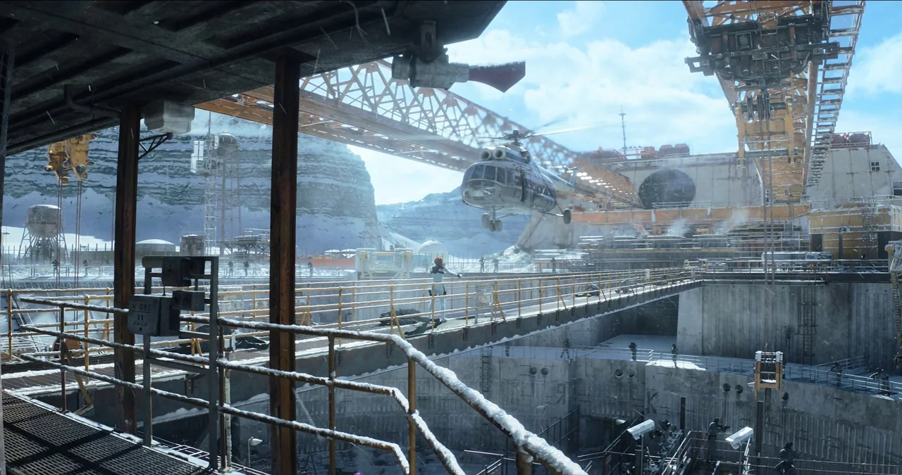 Black Widow (2021) movie still: wide — A sprawling industrial facility set in a snowy mountainous region with large metal gantries. A helicopter…