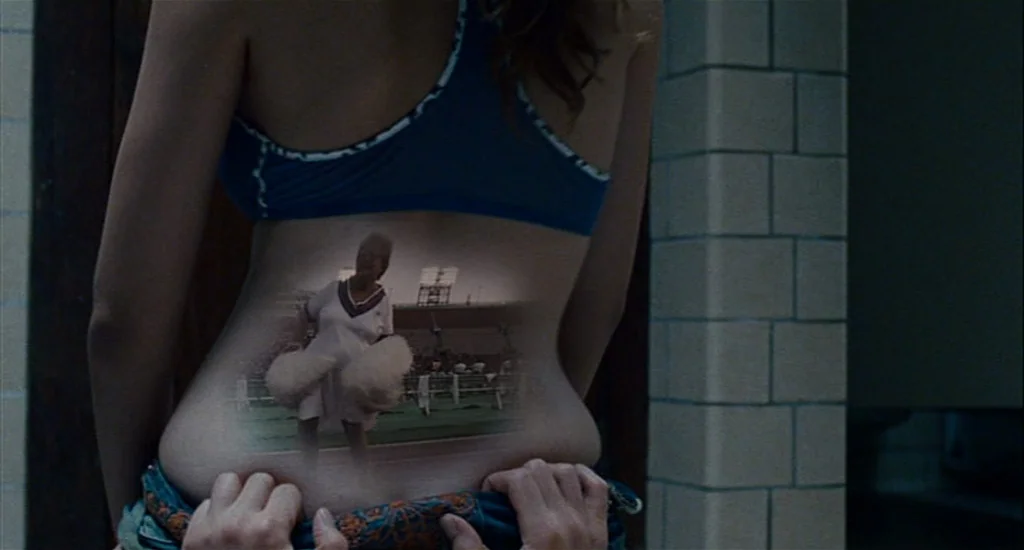 Choke (2008) movie still: medium — A tiled interior wall serves as the backdrop for a person seen from behind. A transparent projection of a…