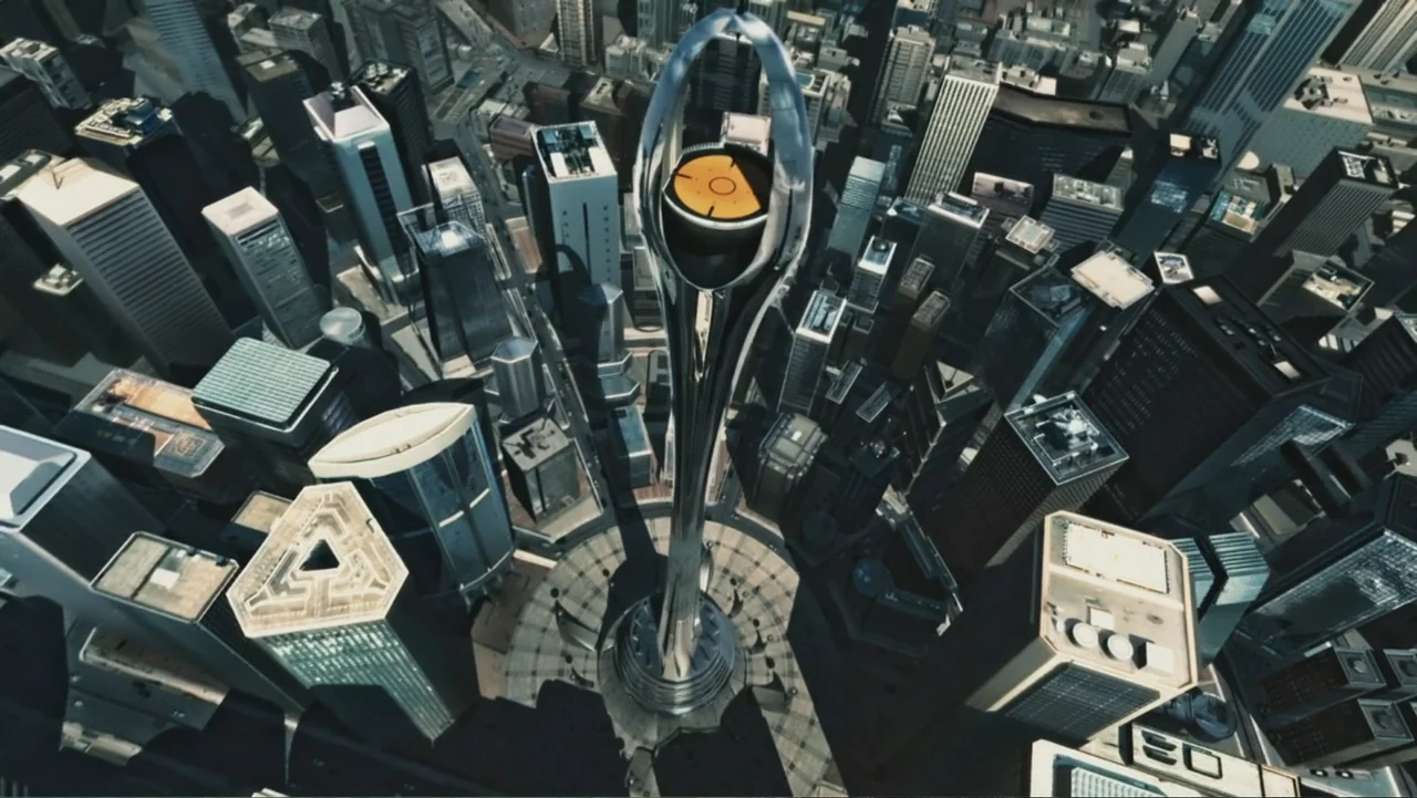 Ultraviolet (2006) movie still: establishing — A dense urban environment features modern skyscrapers surrounding a central tall metallic tower…