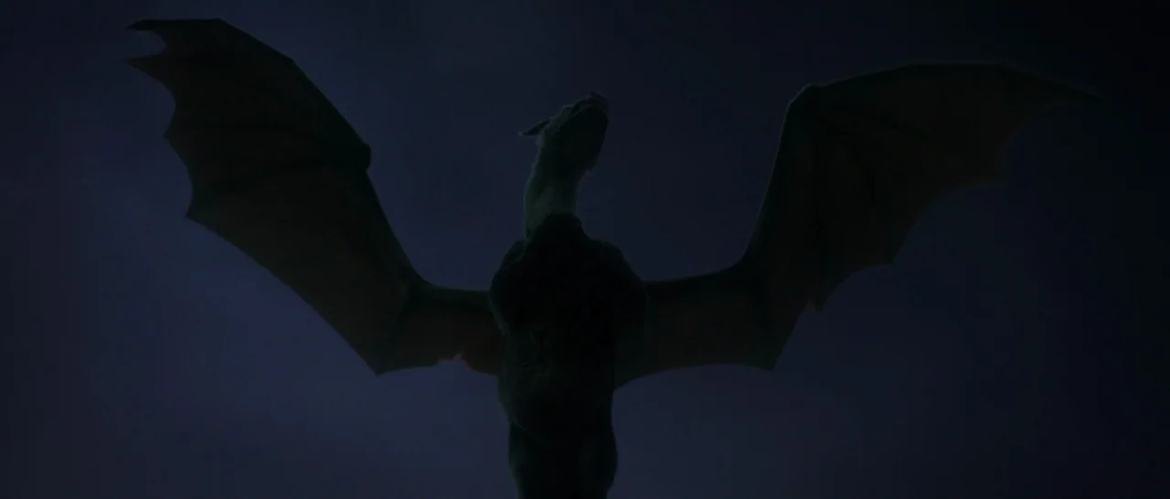 Pete’s Dragon (2016) movie still: fullbody — A dark, expansive night sky serves as the backdrop for a massive winged creature. The creature stands…